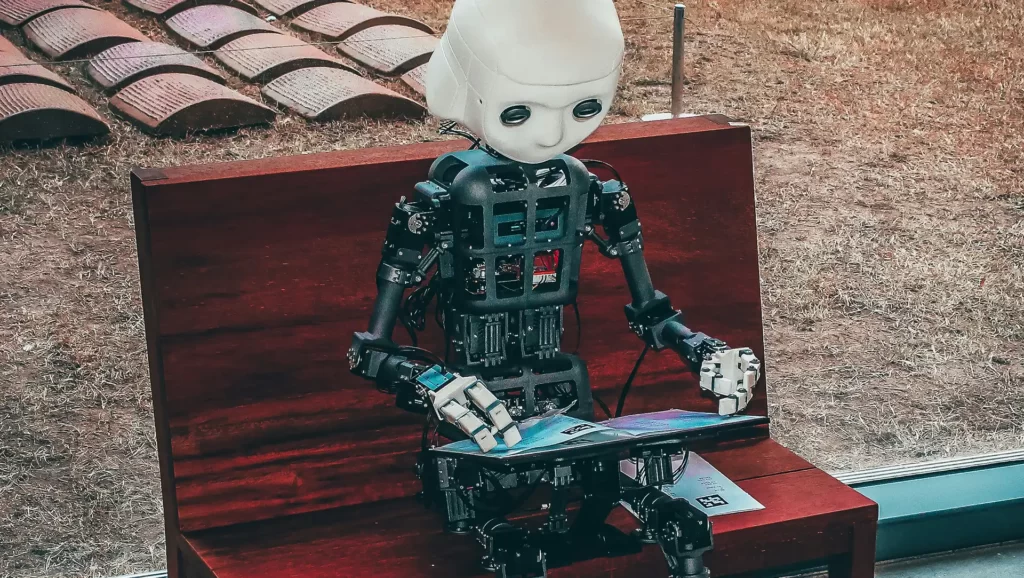 AI for graphic design : An image of a AI robot reading book sitting on a bench