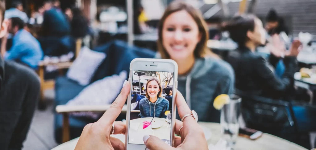 A blog of an image of a person taking a woman photo for How To FYP on TikTok feature image. Photo by Josh Rose on Unsplash
